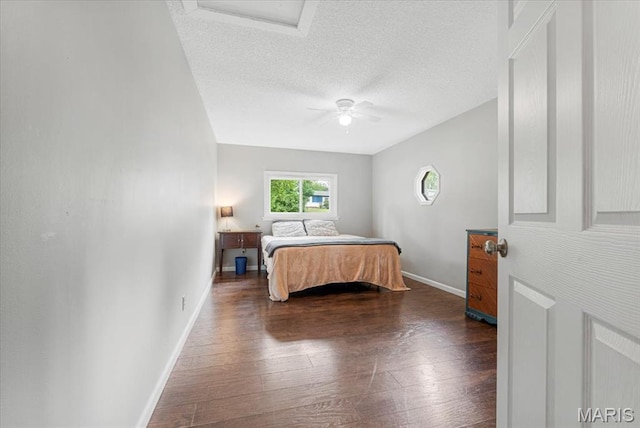 284 Ramsey Ln, Ballwin, MO 63021 - bedroom with dark wood-style floors, baseboards, a textured ceiling, attic access, and a ceiling fan