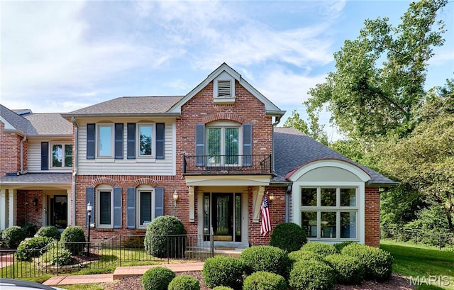 14424 Valley Meadow Ct W, Chesterfield, MO 63017 - view of front of home featuring brick siding, a balcony, a fenced front yard, and roof with shingles