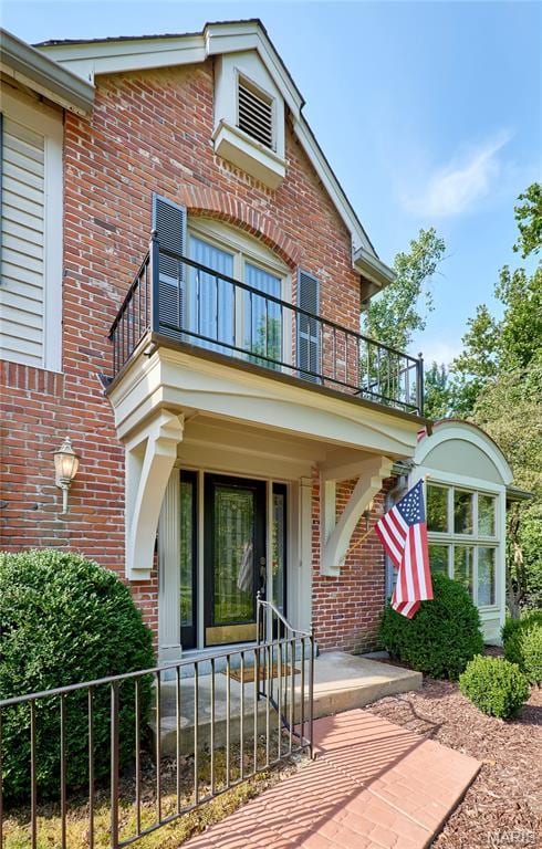 14424 Valley Meadow Ct W, Chesterfield, MO 63017 - view of front of house featuring a balcony, brick siding, and a porch