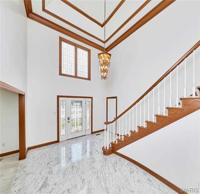 14424 Valley Meadow Ct W, Chesterfield, MO 63017 - foyer entrance featuring crown molding, marble tiled flooring, a high ceiling, stairs, and a chandelier