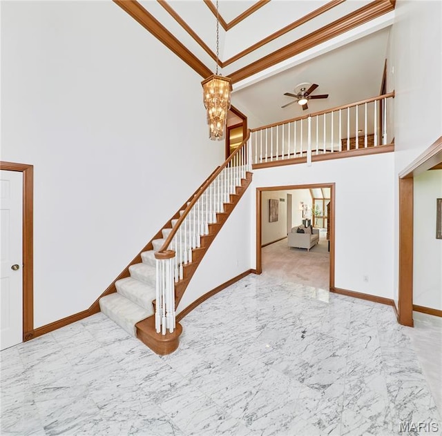14424 Valley Meadow Ct W, Chesterfield, MO 63017 - stairs featuring a towering ceiling, marble tiled flooring, a ceiling fan, a chandelier, and ornamental molding