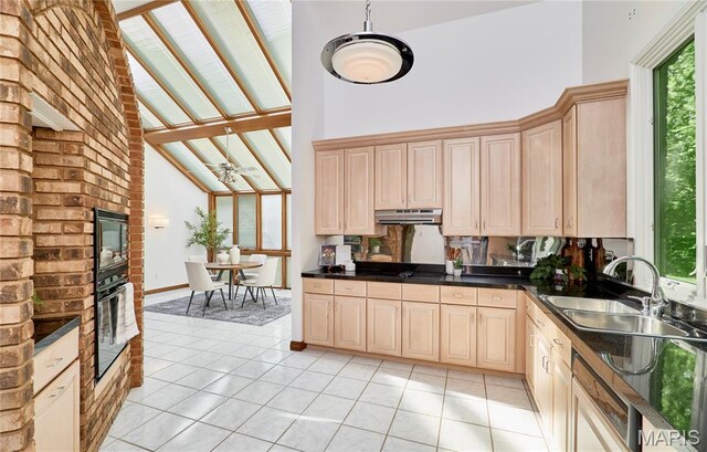 14424 Valley Meadow Ct W, Chesterfield, MO 63017 - kitchen with black appliances, high vaulted ceiling, dark countertops, under cabinet range hood, and light tile patterned floors