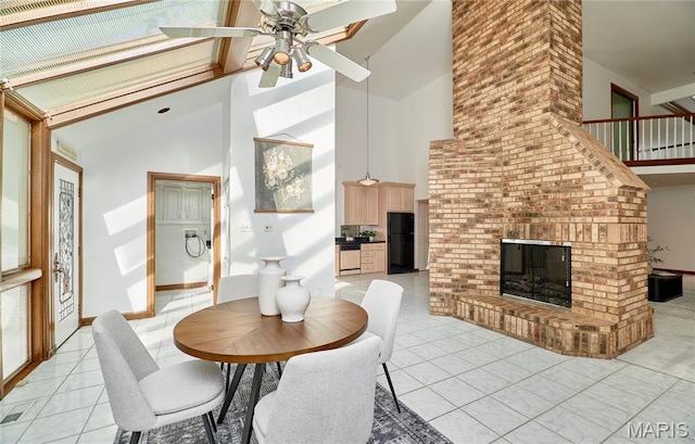 14424 Valley Meadow Ct W, Chesterfield, MO 63017 - dining room with high vaulted ceiling, light tile patterned floors, ceiling fan, and a brick fireplace