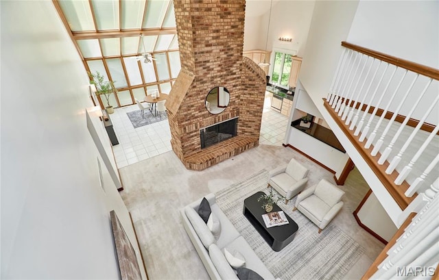 14424 Valley Meadow Ct W, Chesterfield, MO 63017 - living area featuring stairway, a towering ceiling, and a brick fireplace