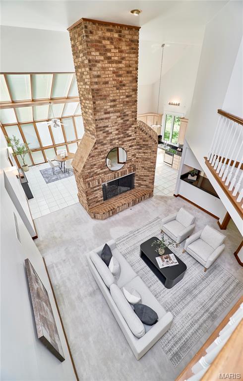 14424 Valley Meadow Ct W, Chesterfield, MO 63017 - living area with a high ceiling, a fireplace, and tile patterned floors