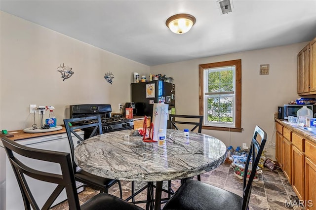 1158 Mulberry St, Bismarck, MO 63624 - dining area featuring dark stone finish floors