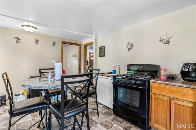 1158 Mulberry St, Bismarck, MO 63624 - kitchen featuring gas stove, stone finish flooring, and brown cabinets