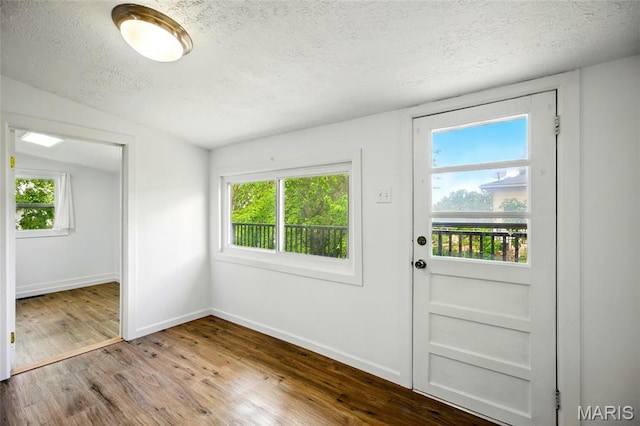 402 N 11th St, De Soto, MO 63020 - doorway featuring a textured ceiling, wood finished floors, and baseboards