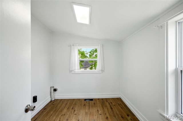 402 N 11th St, De Soto, MO 63020 - unfurnished room featuring wood finished floors, lofted ceiling, and baseboards