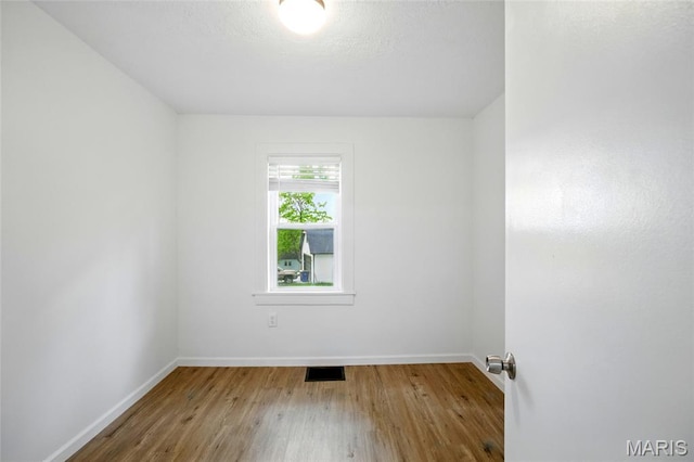 402 N 11th St, De Soto, MO 63020 - spare room with wood finished floors and baseboards
