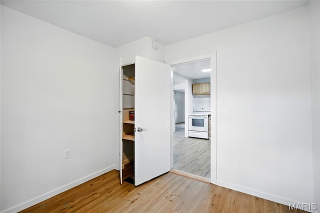 402 N 11th St, De Soto, MO 63020 - unfurnished bedroom with light wood-type flooring and baseboards