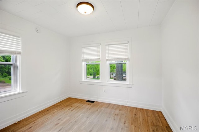 402 N 11th St, De Soto, MO 63020 - spare room featuring light wood-style floors, healthy amount of natural light, and baseboards