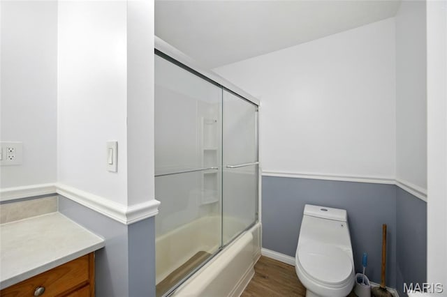 402 N 11th St, De Soto, MO 63020 - bathroom featuring toilet, shower / bath combination with glass door, wood finished floors, and vanity