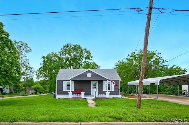 402 N 11th St, De Soto, MO 63020 - view of front of home with covered porch, a detached carport, a front lawn, and concrete driveway