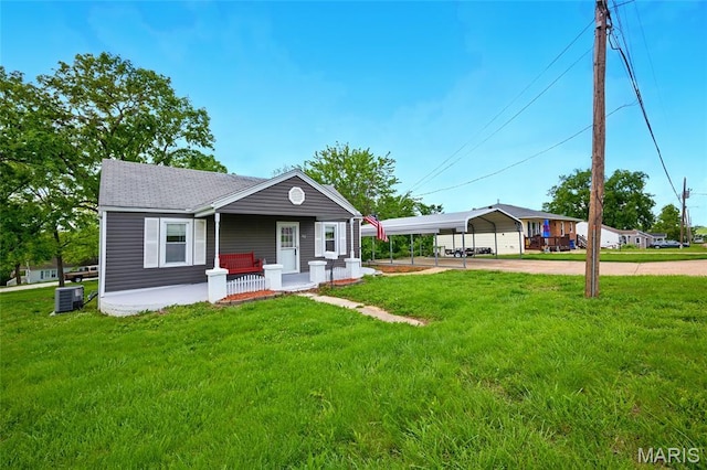 402 N 11th St, De Soto, MO 63020 - view of front of house with a porch, concrete driveway, central air condition unit, a carport, and a front yard
