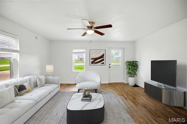 402 N 11th St, De Soto, MO 63020 - living area featuring ceiling fan, wood finished floors, and baseboards