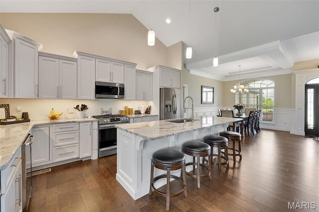 2 Mahogany Run, Farmington, MO 63640 - kitchen featuring appliances with stainless steel finishes, a sink, a chandelier, light stone countertops, and a breakfast bar