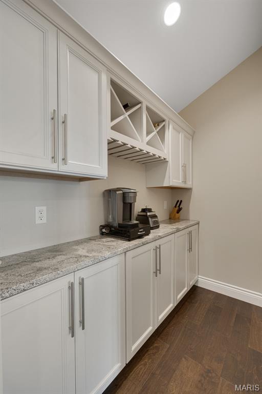 2 Mahogany Run, Farmington, MO 63640 - kitchen featuring dark wood finished floors, white cabinets, baseboards, and light stone counters