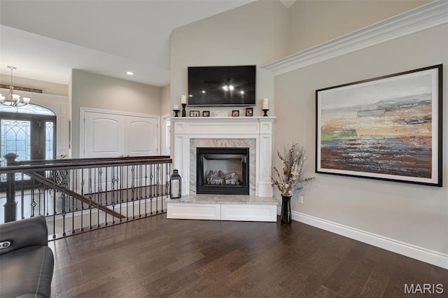 2 Mahogany Run, Farmington, MO 63640 - unfurnished living room featuring dark wood-style flooring, a chandelier, baseboards, high vaulted ceiling, and a fireplace