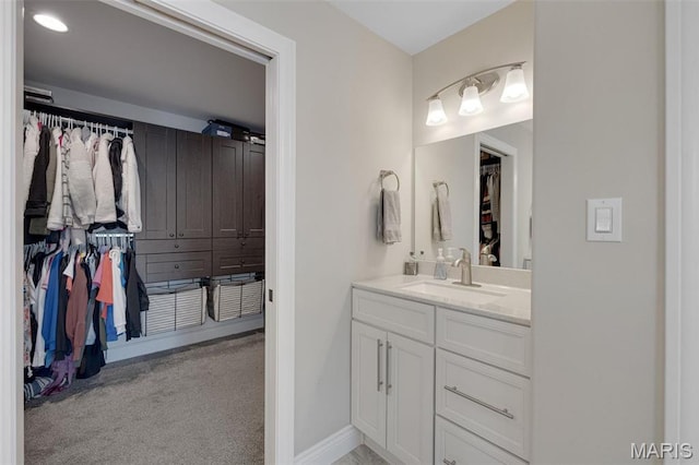 2 Mahogany Run, Farmington, MO 63640 - bathroom featuring vanity, a spacious closet, and baseboards