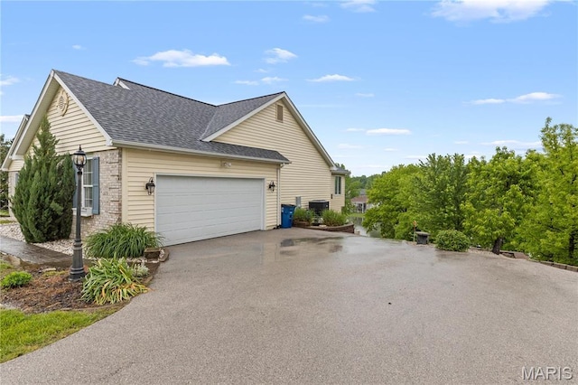 827 Bridgewater Xing, Villa Ridge, MO 63089 - view of side of property with asphalt driveway, roof with shingles, and an attached garage