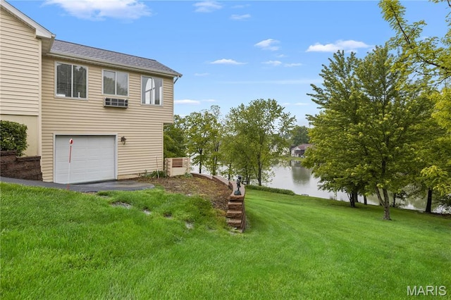 827 Bridgewater Xing, Villa Ridge, MO 63089 - view of grassy yard featuring a water view and an attached garage