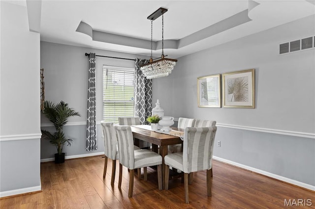 827 Bridgewater Xing, Villa Ridge, MO 63089 - dining room with wood finished floors, baseboards, a tray ceiling, and a chandelier