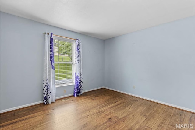 827 Bridgewater Xing, Villa Ridge, MO 63089 - unfurnished room with wood finished floors and baseboards