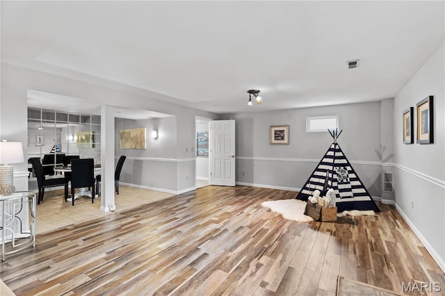 827 Bridgewater Xing, Villa Ridge, MO 63089 - recreation room featuring wood finished floors and baseboards