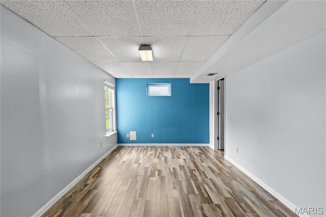 827 Bridgewater Xing, Villa Ridge, MO 63089 - unfurnished room featuring a drop ceiling, wood finished floors, and baseboards