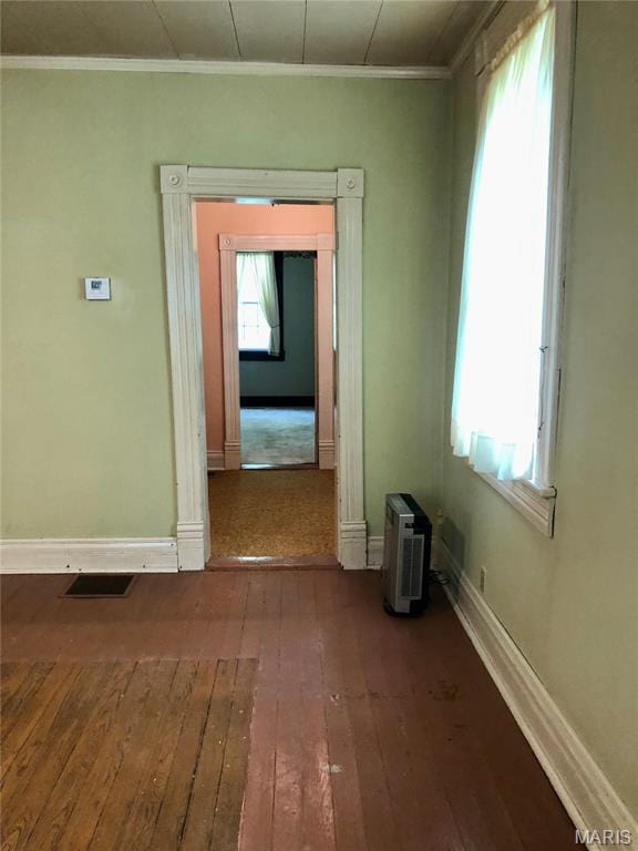 unfurnished room featuring hardwood / wood-style flooring, baseboards, and ornamental molding