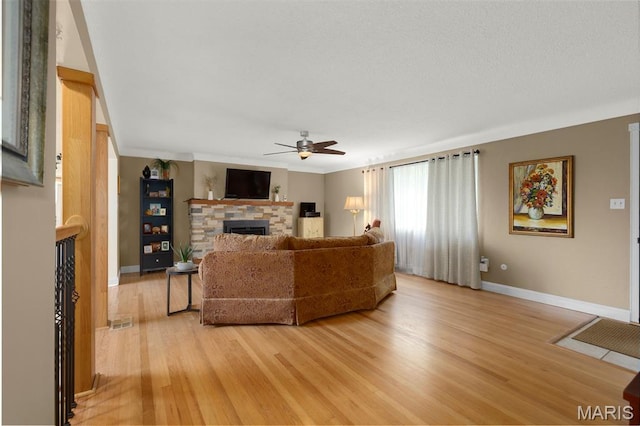 1261 Whispering Winds Dr, Arnold, MO 63010 - living room featuring a fireplace, ceiling fan, and light wood finished floors