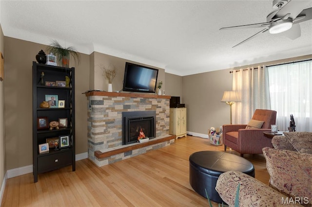 1261 Whispering Winds Dr, Arnold, MO 63010 - living room with ceiling fan, light wood-style floors, and a fireplace