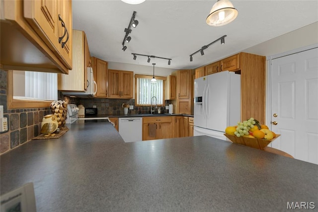 1261 Whispering Winds Dr, Arnold, MO 63010 - kitchen with white appliances, dark countertops, backsplash, decorative light fixtures, and brown cabinetry