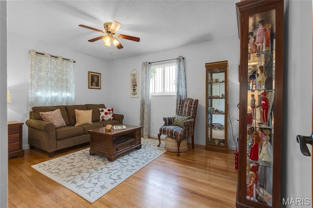 1261 Whispering Winds Dr, Arnold, MO 63010 - living room with a ceiling fan, light wood-style floors, and a textured ceiling