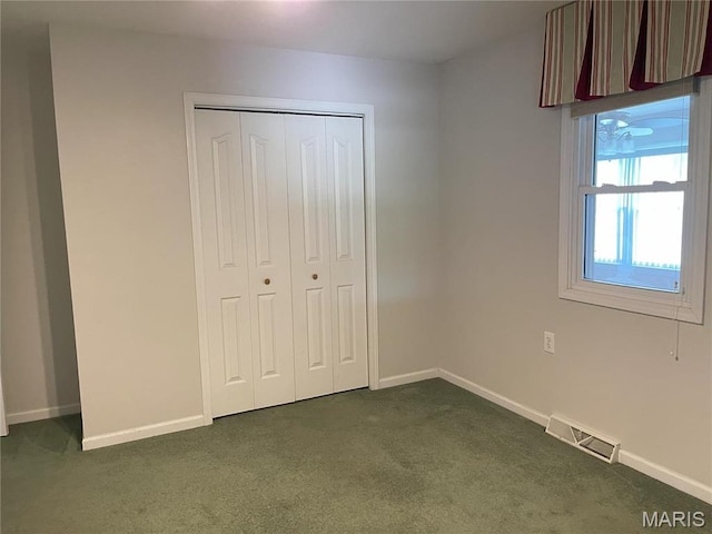 408 Crestview St, Cuba, MO 65453 - unfurnished bedroom with dark carpet, baseboards, and a closet