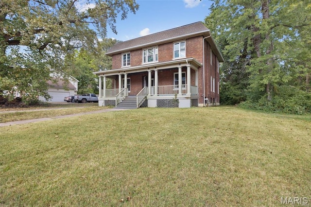 colonial-style house featuring covered porch, brick siding, and a front yard
