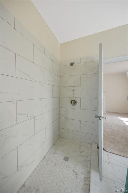 bathroom with tiled shower