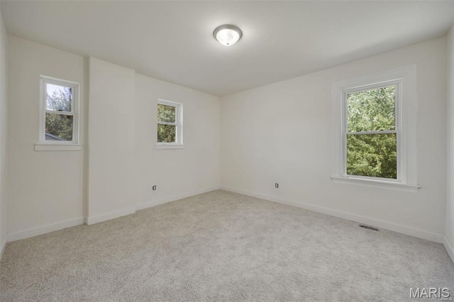 carpeted spare room with baseboards