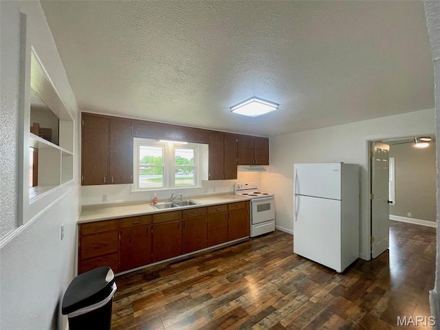 27 Moore St, Farmington, MO 63640 - kitchen with white appliances, a sink, light countertops, under cabinet range hood, and dark wood-style flooring