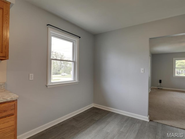 324 E Olive St, Palmyra, MO 63461 - unfurnished dining area featuring dark wood finished floors and baseboards