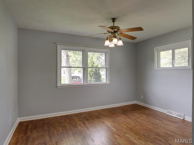 324 E Olive St, Palmyra, MO 63461 - spare room with healthy amount of natural light, wood finished floors, baseboards, and a ceiling fan