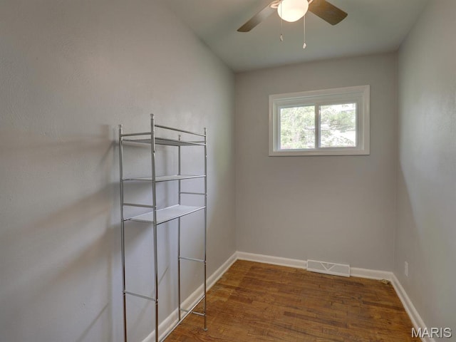 324 E Olive St, Palmyra, MO 63461 - unfurnished room with wood finished floors, a ceiling fan, and baseboards