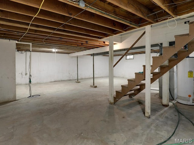 324 E Olive St, Palmyra, MO 63461 - unfinished below grade area featuring gas water heater and stairway