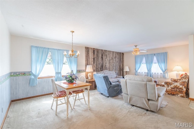 127 Chippewa, Piedmont, MO 63957 - living room featuring a chandelier, light colored carpet, ceiling fan, baseboards, and wainscoting