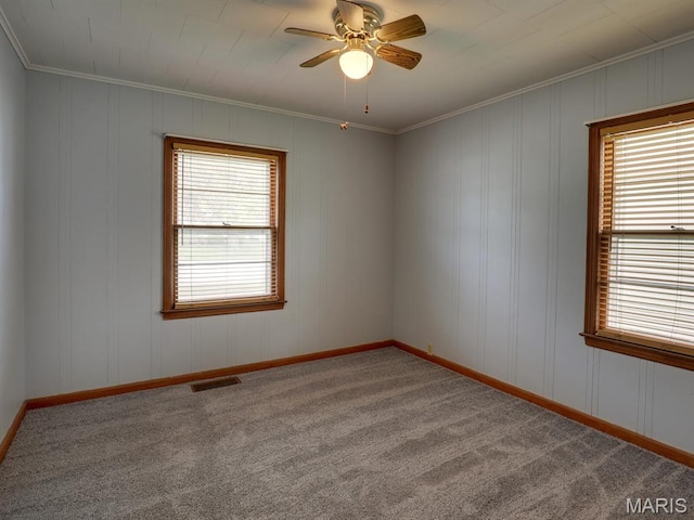 spare room with ornamental molding, ceiling fan, and carpet floors