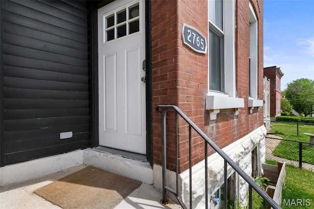 2765 Caroline St, Saint Louis, MO 63104 - doorway to property featuring brick siding and fence