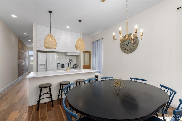 2765 Caroline St, Saint Louis, MO 63104 - dining space with wood finished floors, a chandelier, and recessed lighting