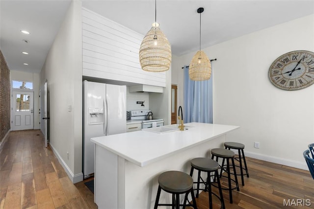 2765 Caroline St, Saint Louis, MO 63104 - kitchen featuring white appliances, a sink, dark wood-type flooring, baseboards, and recessed lighting