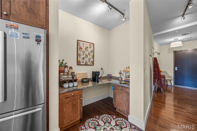 9 N Euclid Ave Unit 303, Saint Louis, MO 63108 - kitchen with freestanding refrigerator, track lighting, dark wood finished floors, and stone countertops